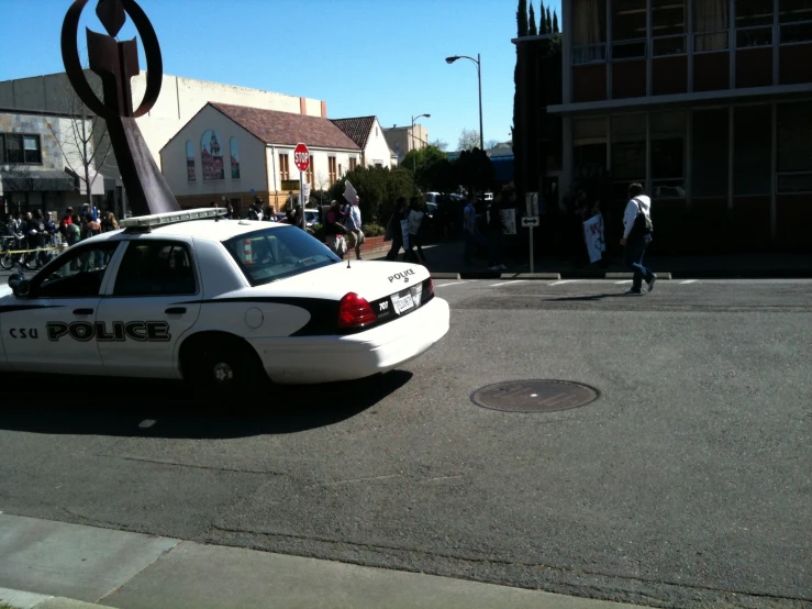 a police car is stopped at a red light