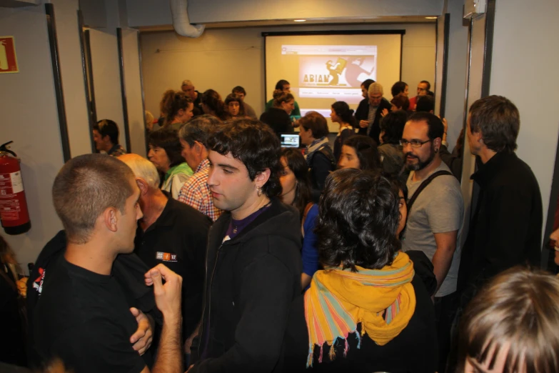 group of people standing together in front of a projector screen