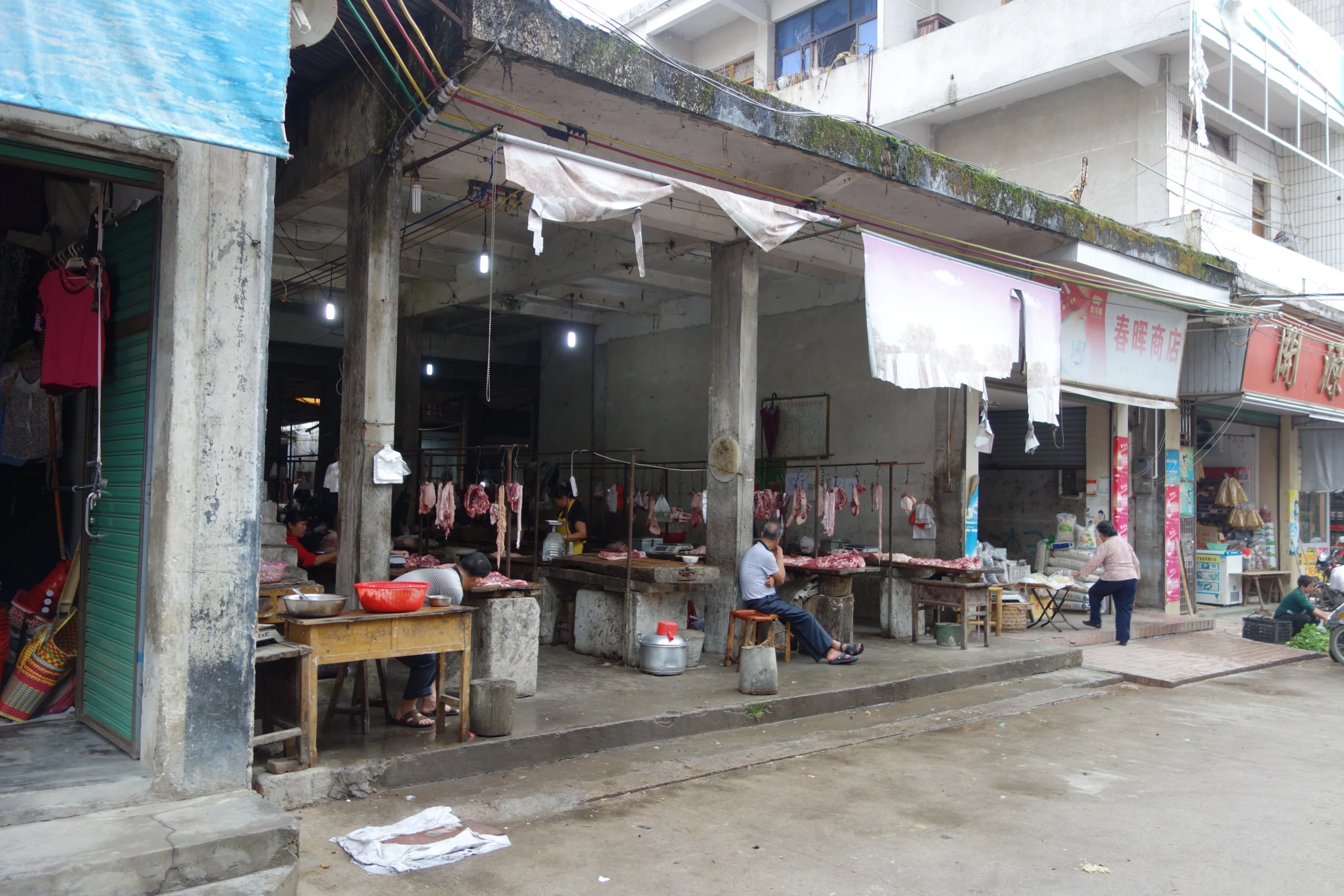 a person standing near a street with a market in it