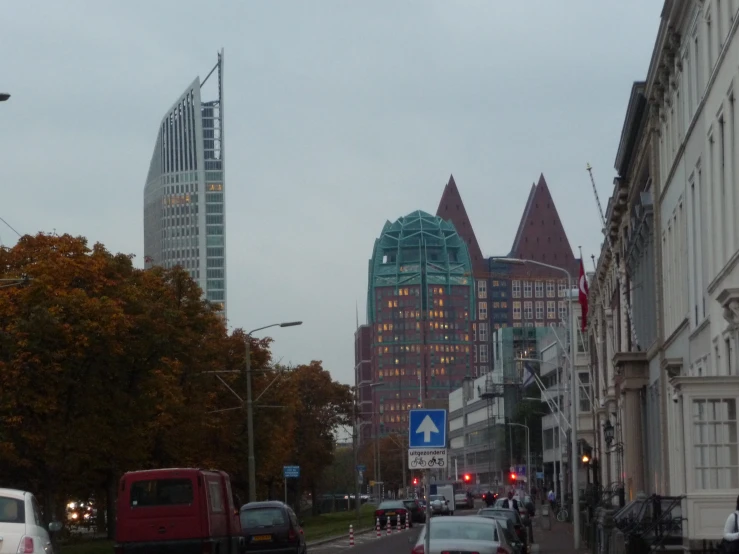 vehicles parked in front of large buildings on the road