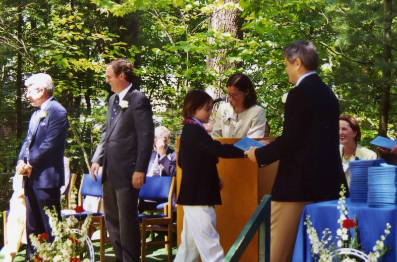 a group of people standing around and shaking hands