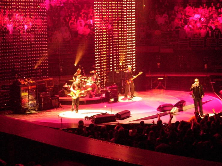 an image of band performing on stage with lights