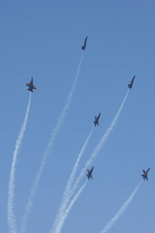 a formation of airplanes fly in the air