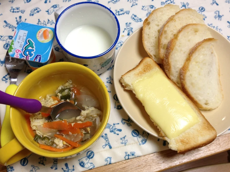 a plate with some toast and a bowl of soup