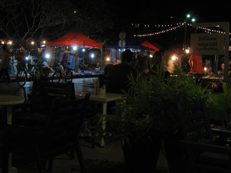 an outdoor restaurant with lighted umbrellas and tables