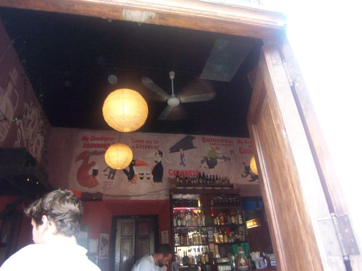 the view through a door at a bar with bottles