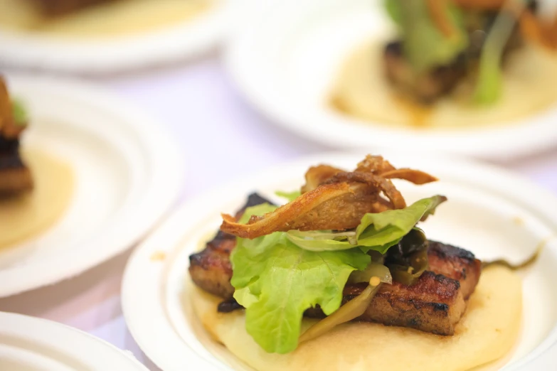 a small assortment of prepared and cooked food items on white plates