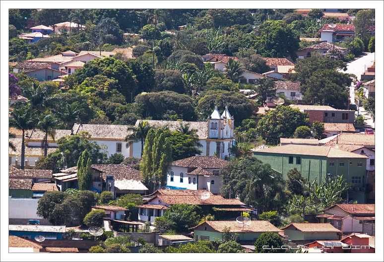 a white church tower on top of a small town