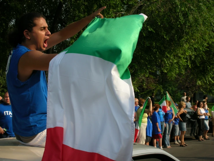 the woman is holding her flag near other people