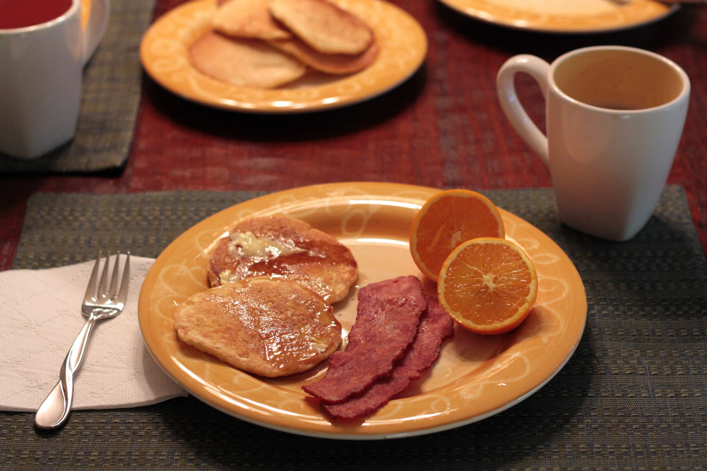 an orange plate is served with french toast and orange slices