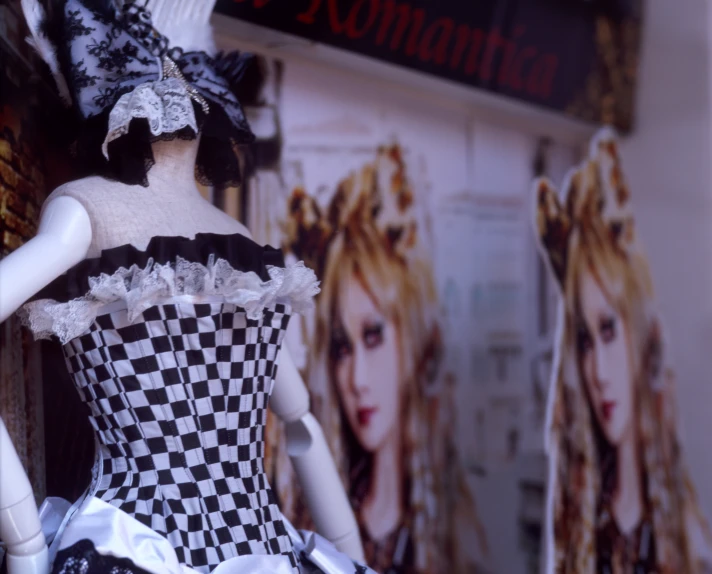 the dress made out of a doll is next to posters