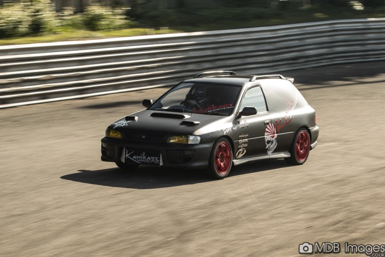 the modified car is driving around a corner on a race track