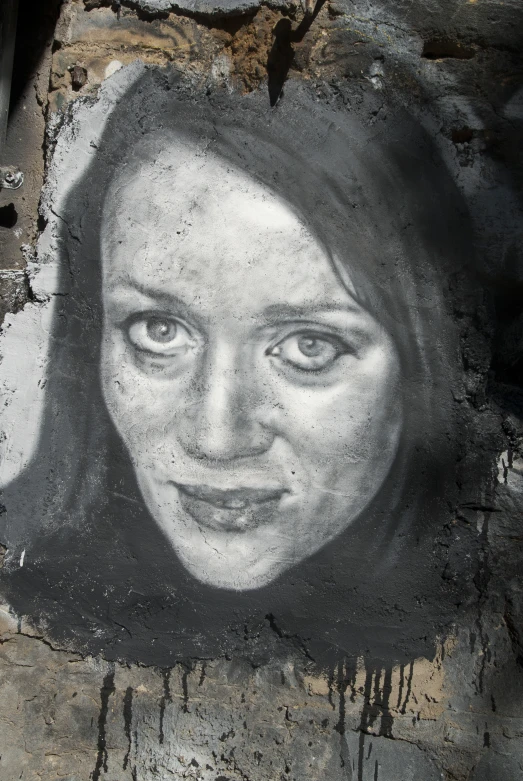 the portrait of a woman is painted on concrete