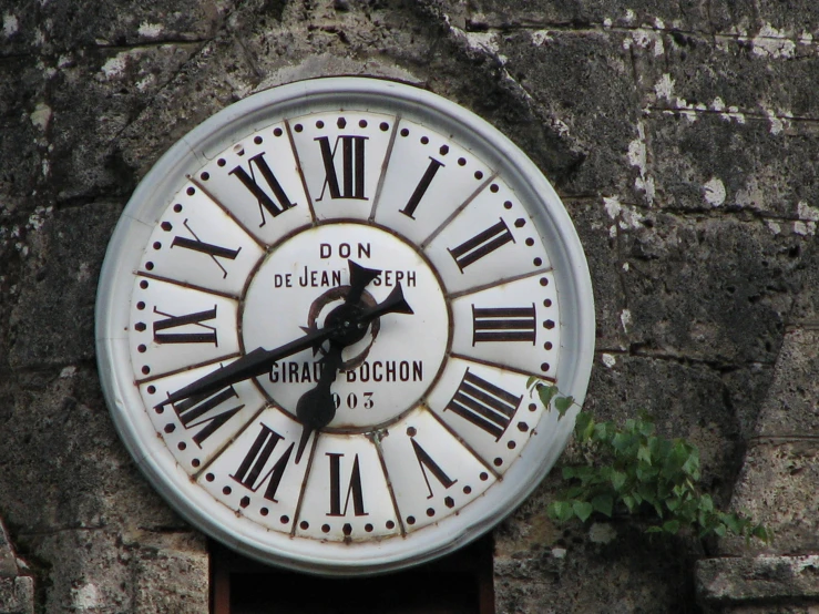 the large clock is mounted on the building