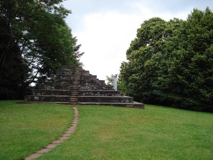 the green grassy field is set in a pyramid shape with steps going up and down