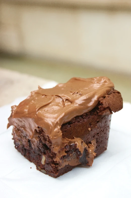 a single piece of cake with chocolate frosting