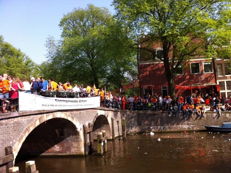 a large crowd of people are in front of the bridge