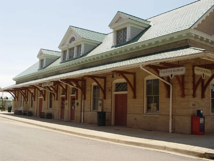 a train station with a red light on the train