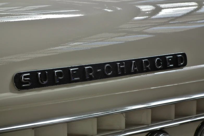 an old car with the word super charged on the front grille
