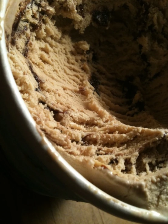 ice cream in a white bowl sits in a brown counter