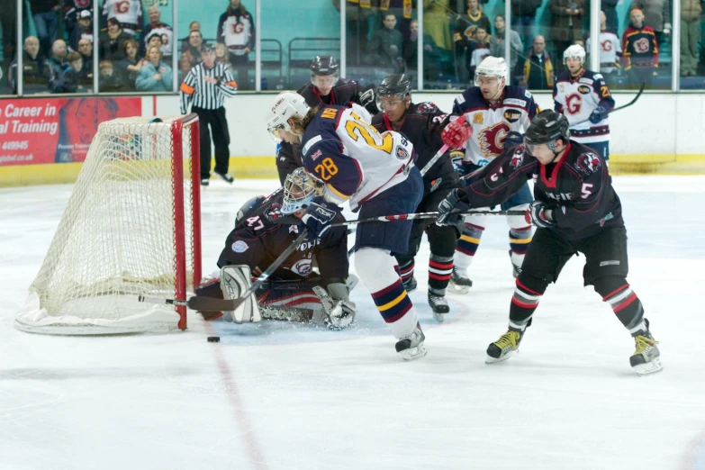 the men are playing ice hockey in a game