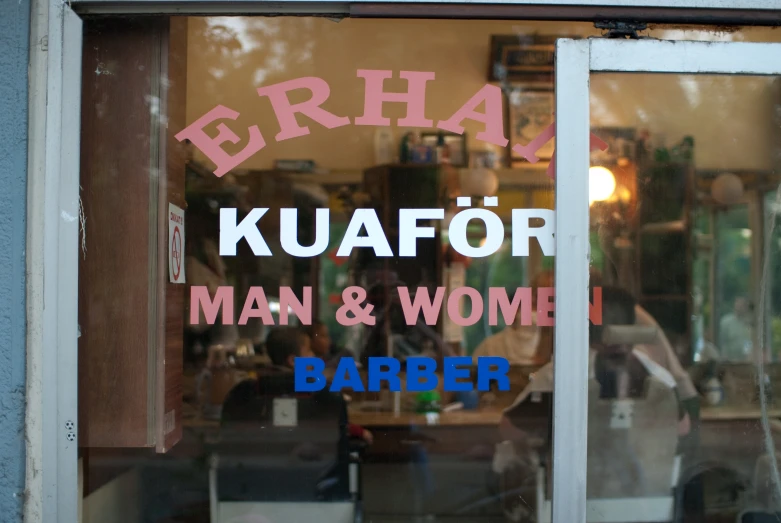 a store front has an asian man and woman sign in the window