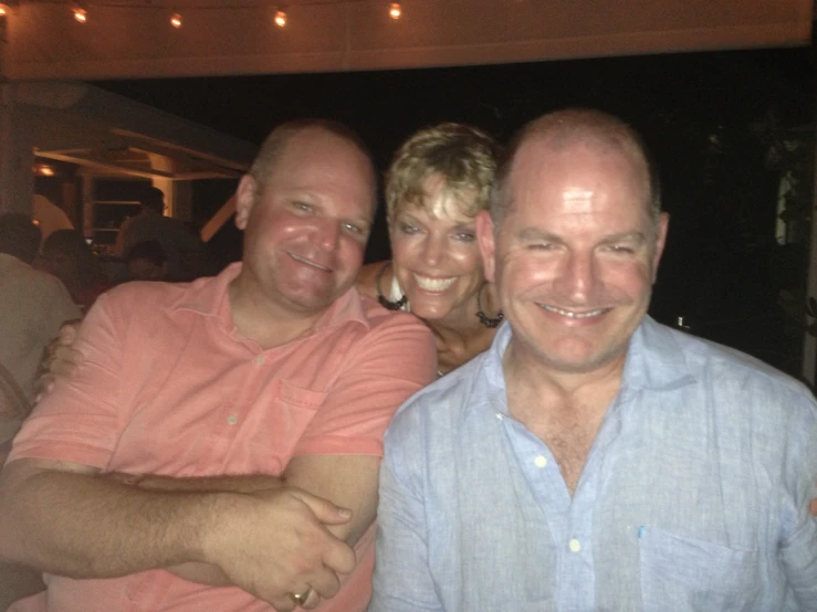 three people sitting down at a dinner in a restaurant