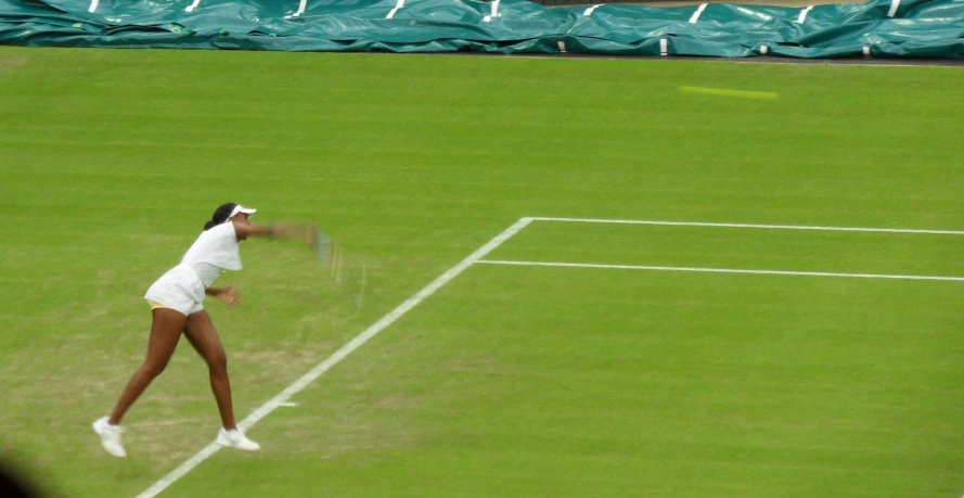 the tennis player is preparing to serve the ball