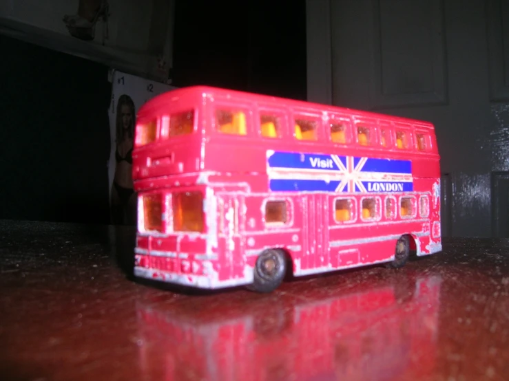 a toy bus with flags painted on the side of it