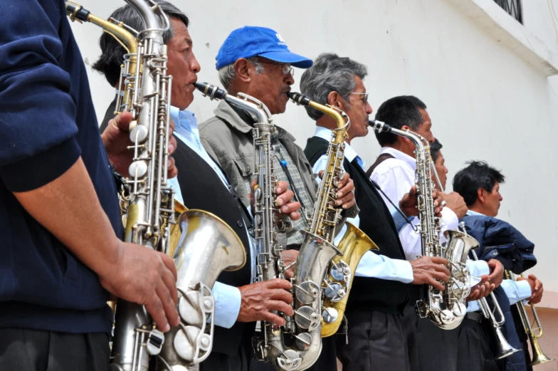 a group of men standing next to each other playing ss instruments