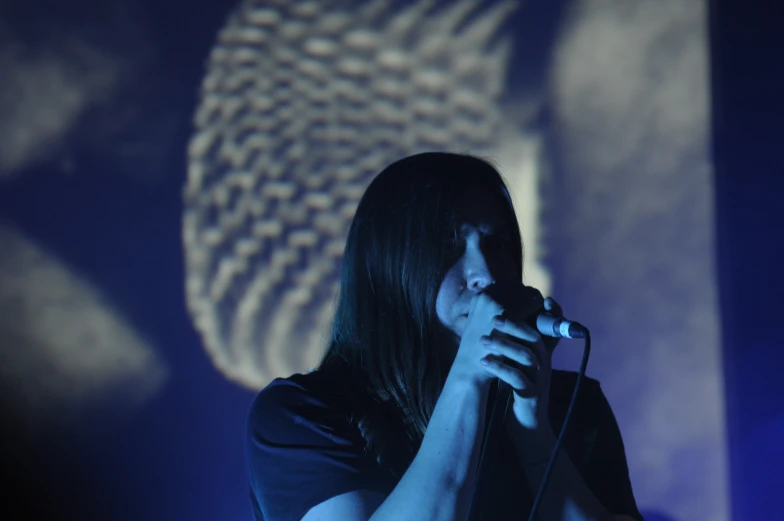 a female singer is performing on stage with microphone