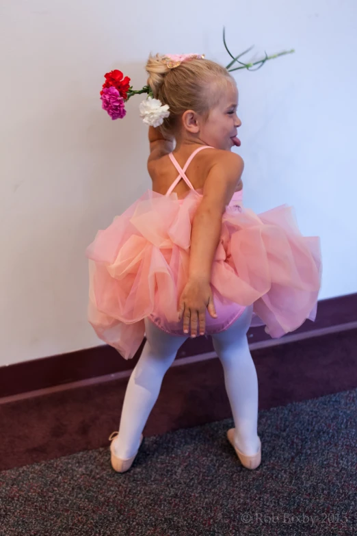 the little girl is wearing a dress made of tulle and shoes