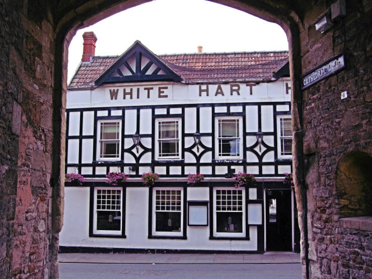 a white and black building with flowers on it