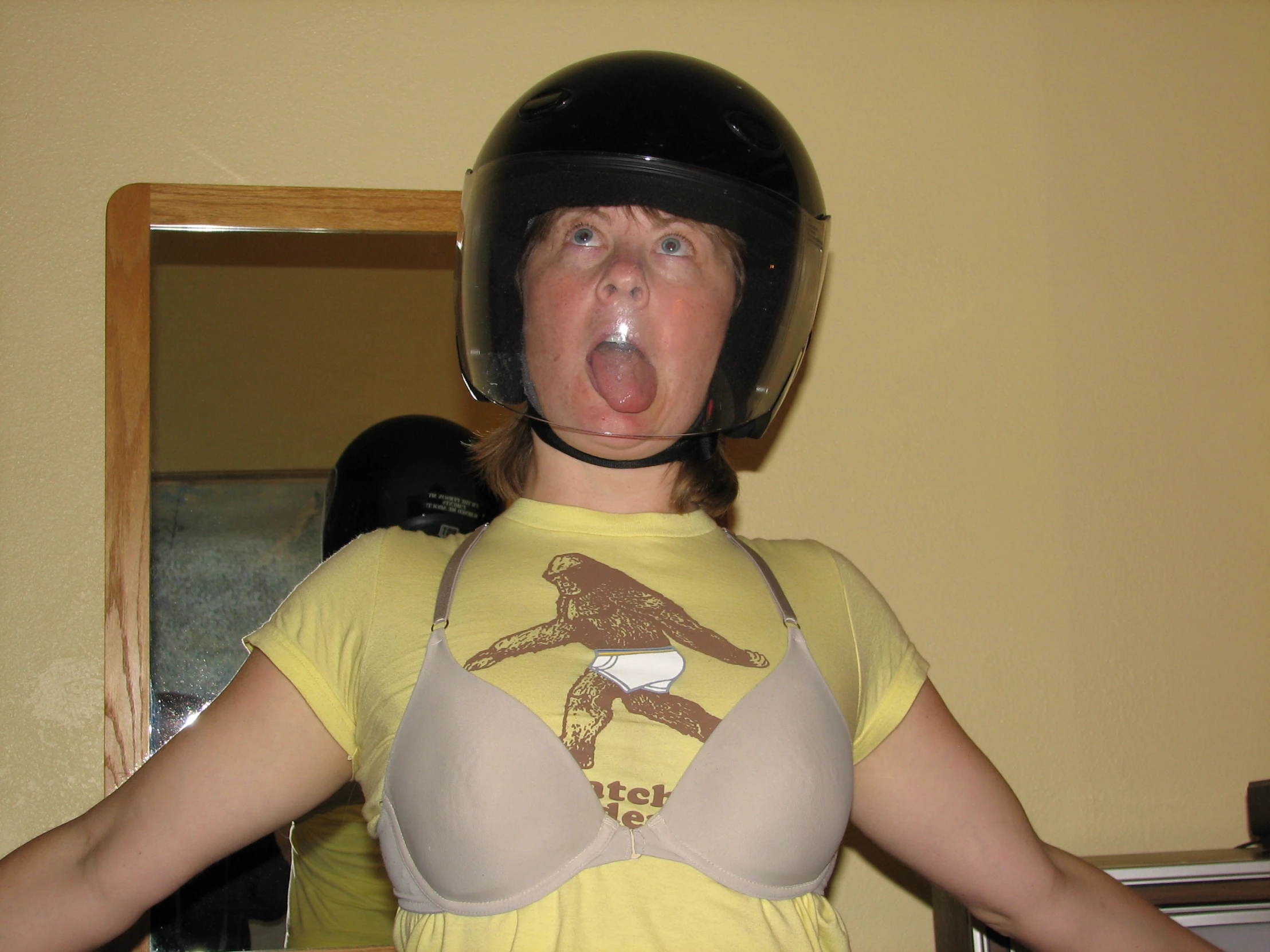 woman with helmet posing for picture at mirror