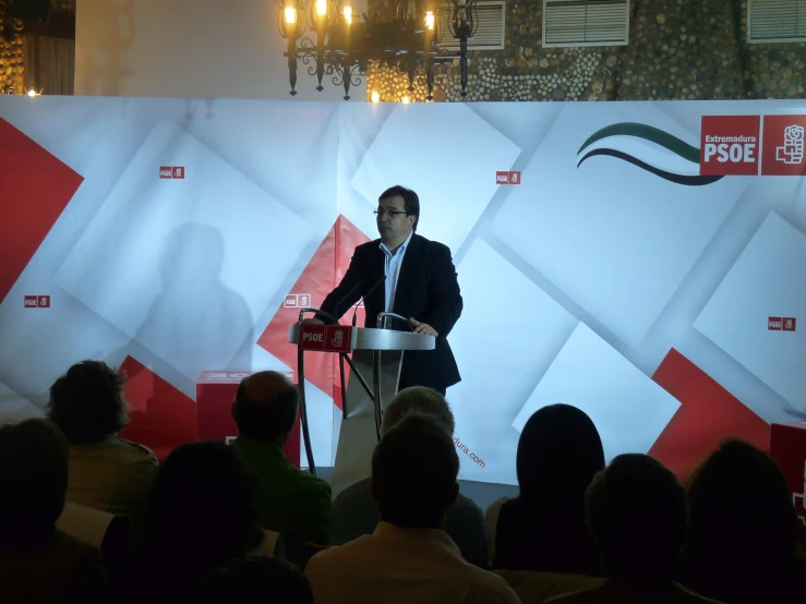 a man standing behind a podium giving a speech