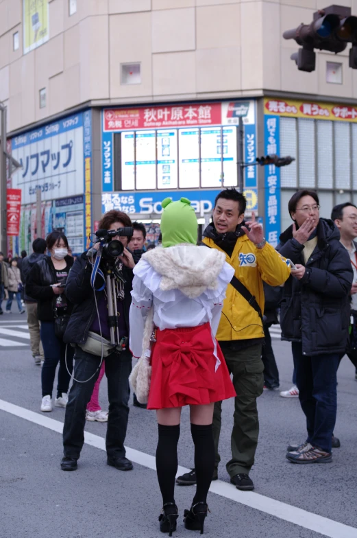 two people dressed in costumes and walking on the street