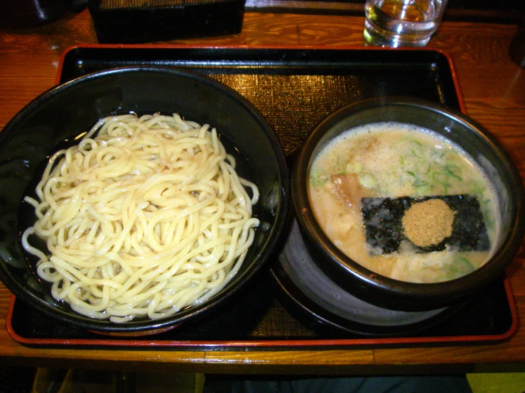 three bowls of noodles and other different dishes
