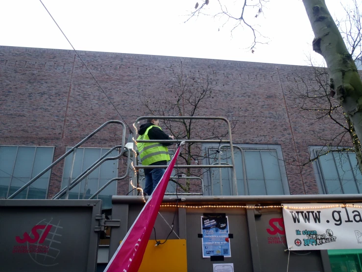 a man in high visibility on a lift