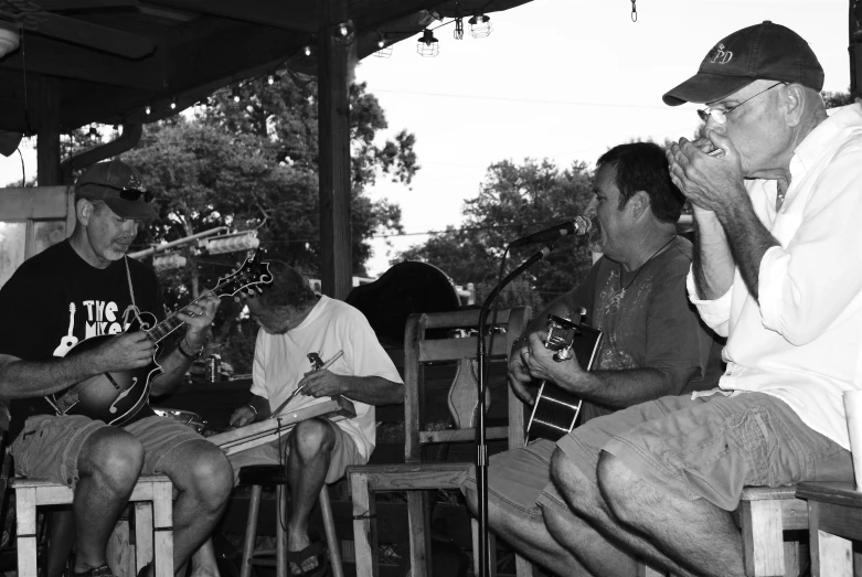 a man is playing a guitar while others play guitar