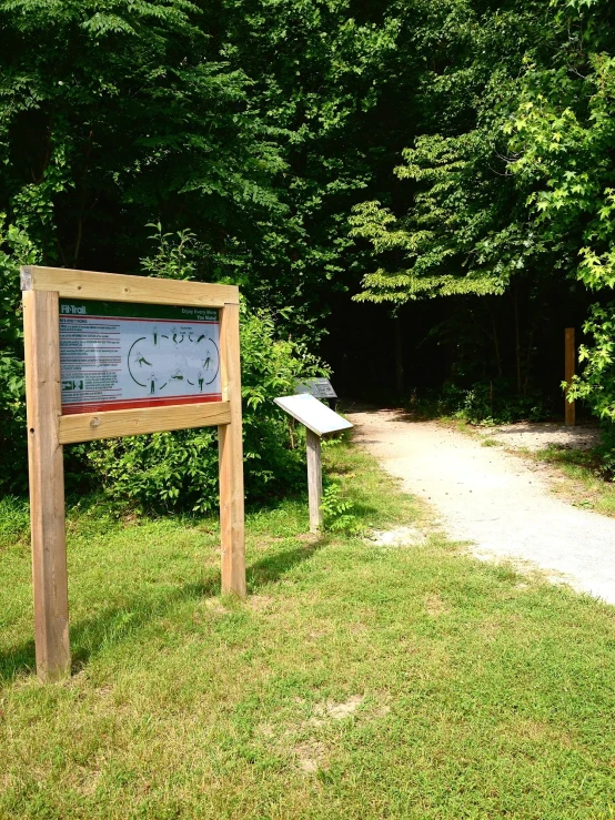 a sign for the park in a wooded area