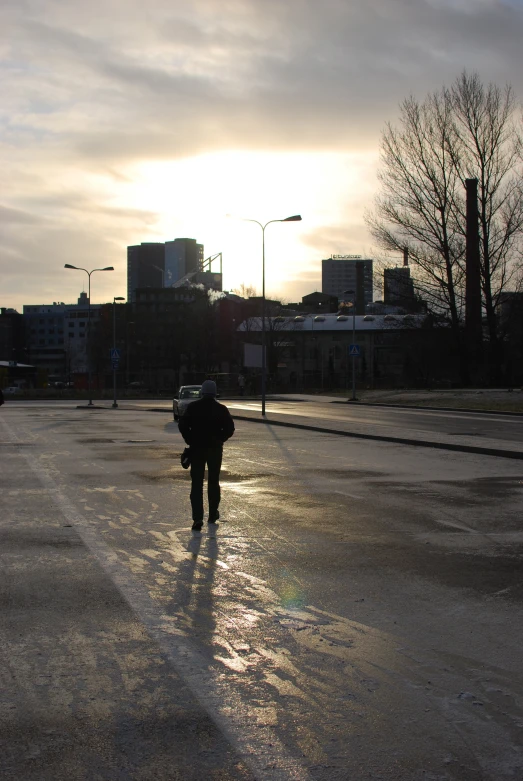 a man that is walking on a wet street