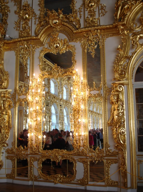 the walls and walls of a room decorated with gold colored artwork