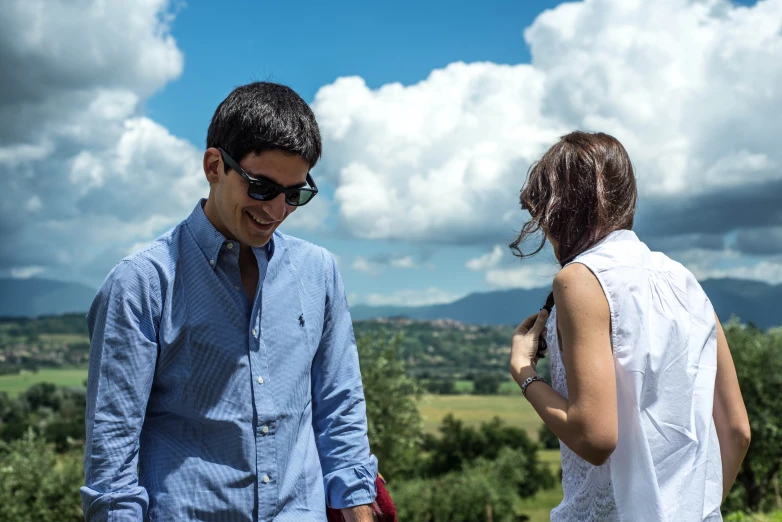 a man and woman looking at soing in the distance