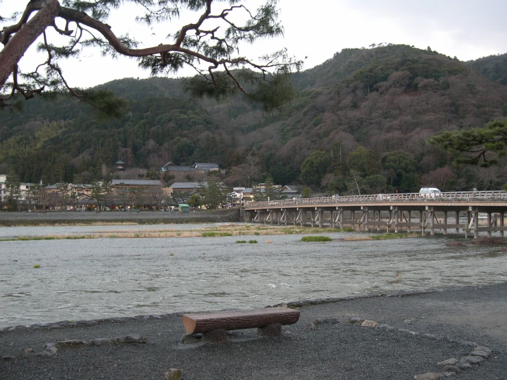 wooden bench overlooking the water on a river bank