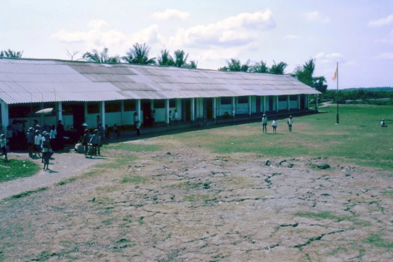 people standing outside of some kind of school building