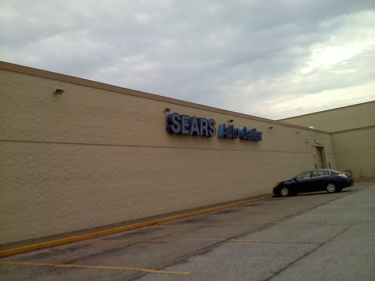 a large store is shown with cars parked outside