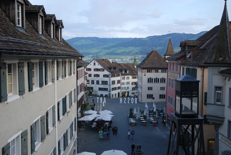 a street with tables on the side and some buildings along the sides