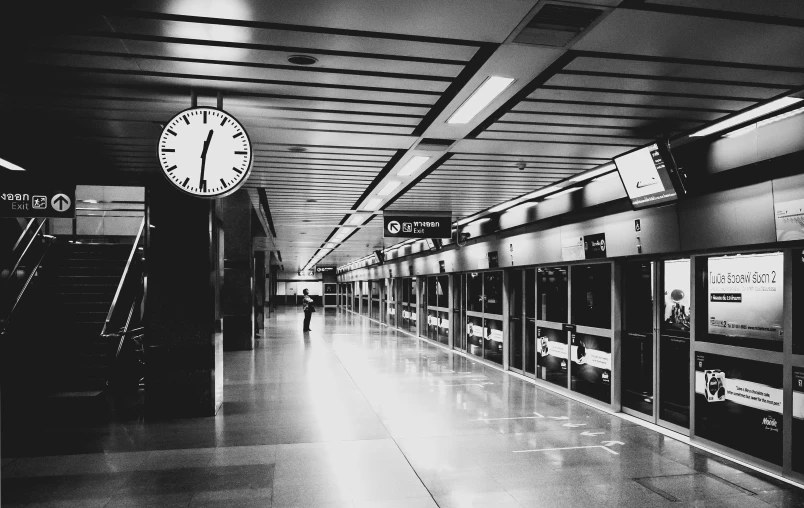 black and white po with a clock and escalator