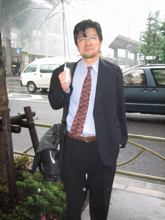 a man in a suit with an umbrella