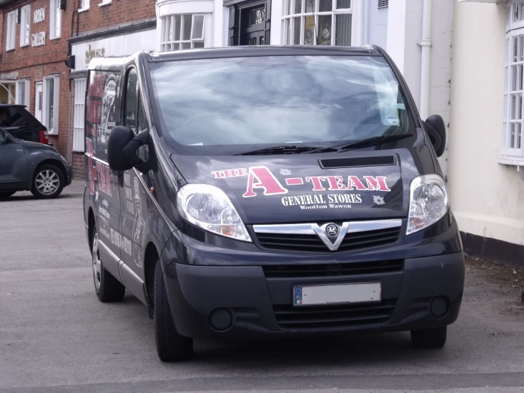 the van is parked in the parking lot by the building